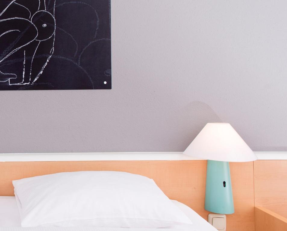 Postel nebo postele na pokoji v ubytování ibis Berlin City Nord