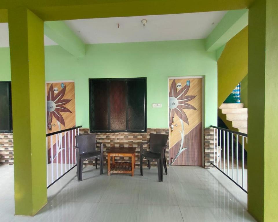 a room with a table and chairs and a stage at Luciano Guest House in Arambol