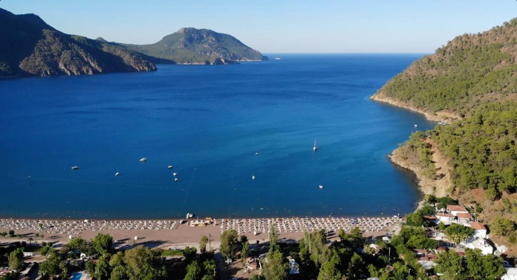 a beach with a large group of people in the water at Linaden Apart in Kumluca