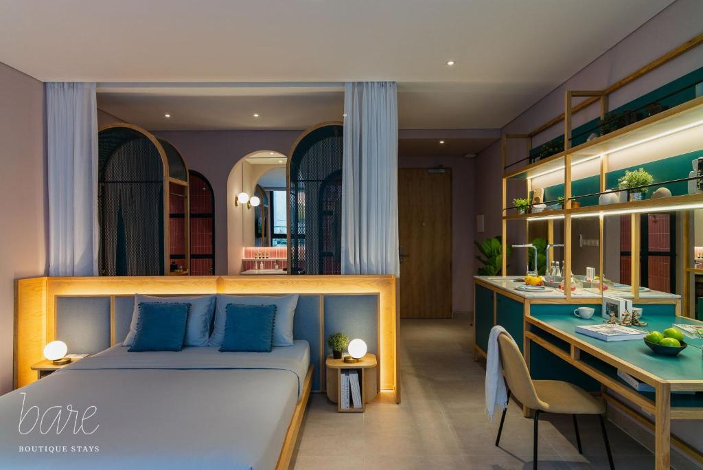 a bedroom with a bed and a desk in a room at Bare Han - Bare Boutique Stays in Da Nang