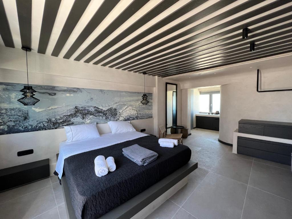 Postel nebo postele na pokoji v ubytování ArmonOia Suites