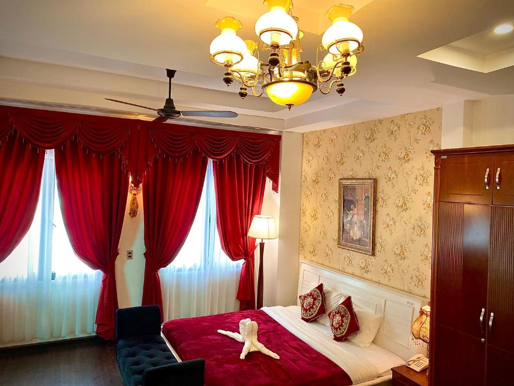 a bedroom with a red bed with a starfish on it at Doc May Boutique Villa in Da Lat