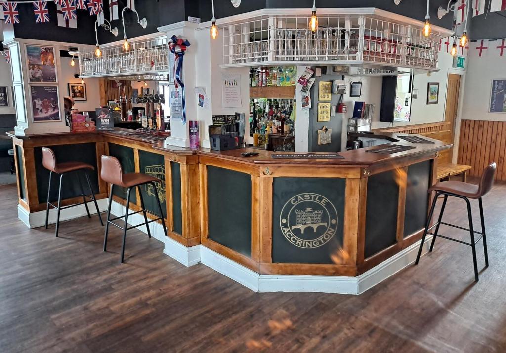 a bar in a pub with two stools at OYO Castle Hotel, Accrington in Accrington