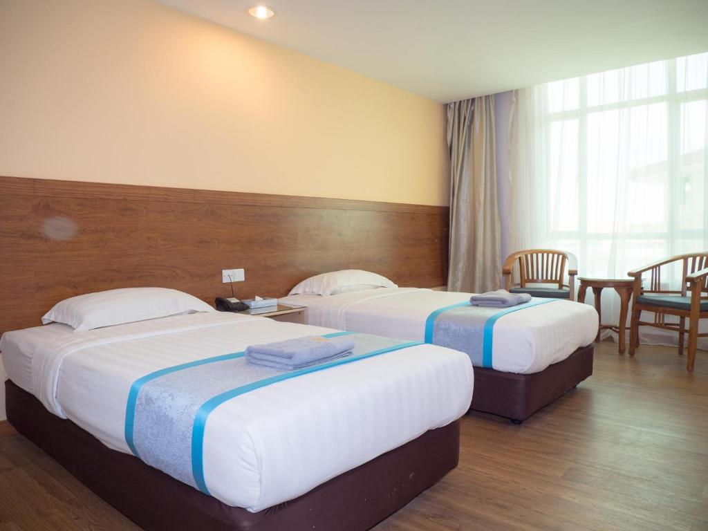 Postel nebo postele na pokoji v ubytování TD Mutiara Hotel Semporna