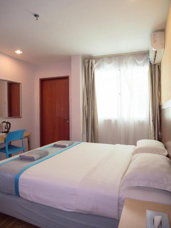 Postel nebo postele na pokoji v ubytování TD Mutiara Hotel Semporna
