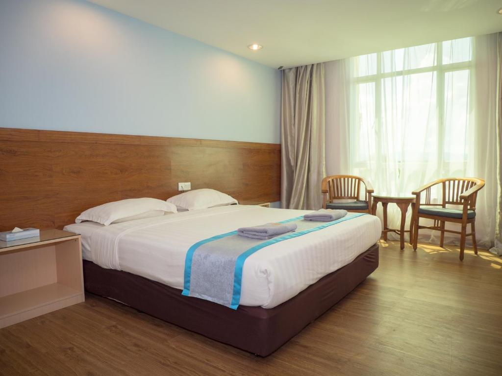 Postel nebo postele na pokoji v ubytování TD Mutiara Hotel Semporna