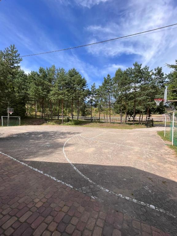 an empty basketball court with trees in the background at Chata Baryła in Sulęczyno