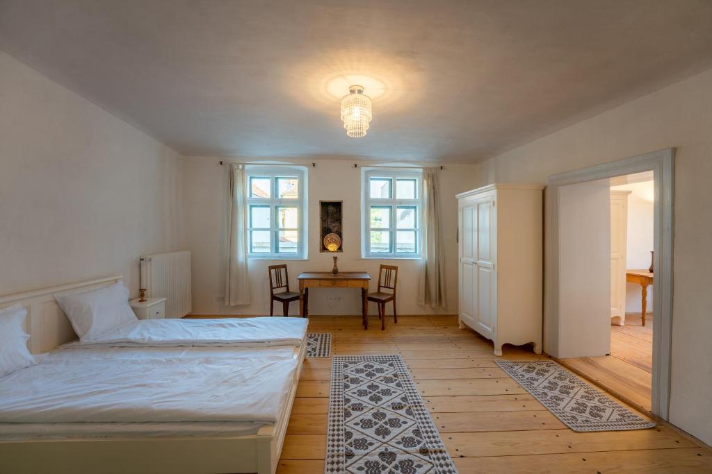 a bedroom with a bed and a table and chairs at Casa La Strada in Sighişoara