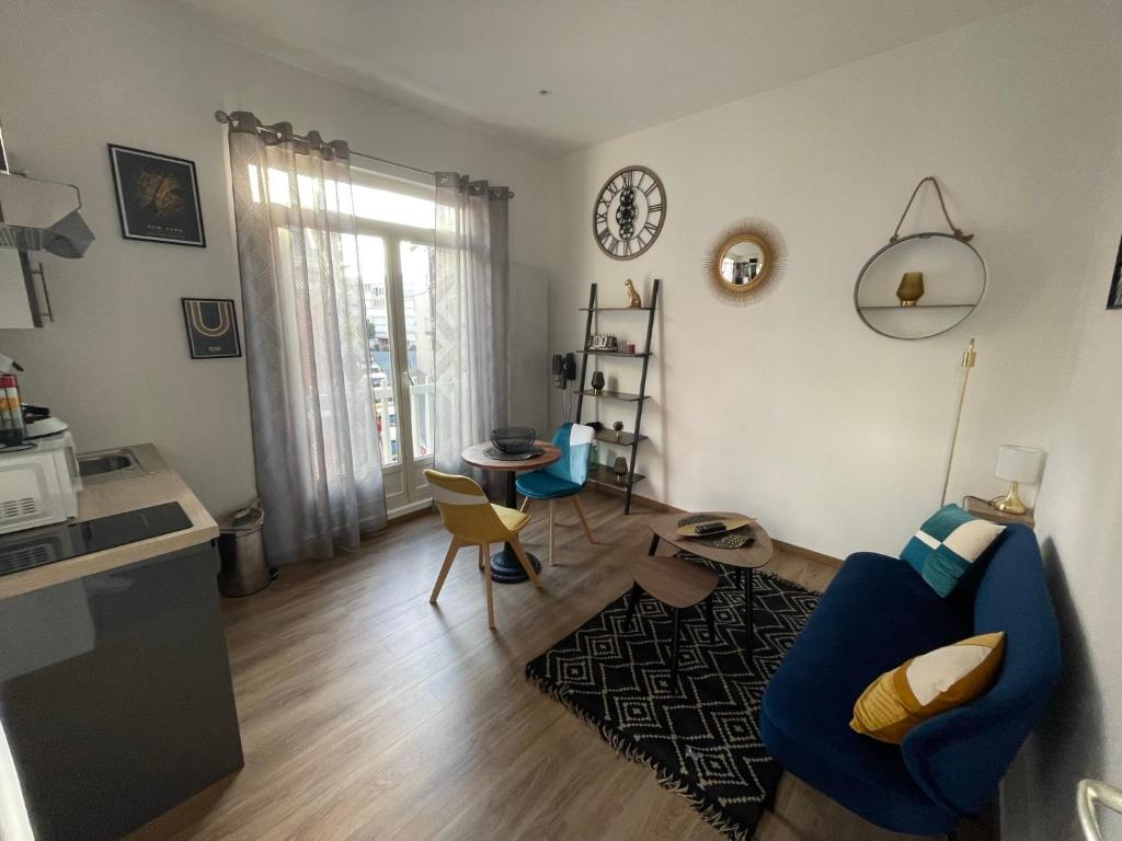 un salon avec un canapé bleu et une table dans l'établissement 2- Quartier historique aux pieds des falaises, au Tréport