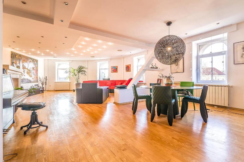 a large living room with a table and chairs at Modern City-Centre Penthouse with Spectacular Views / 135sqm in Zagreb