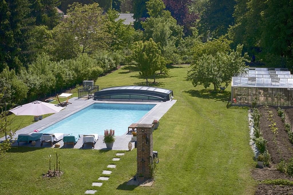 an overhead view of a swimming pool in a yard at Le Logis Du Regisseur in Charny