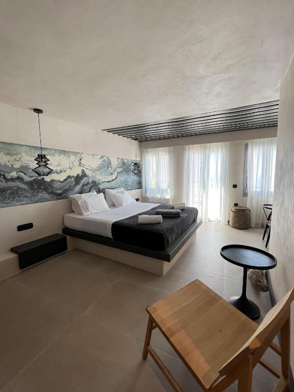 Postel nebo postele na pokoji v ubytování ArmonOia Suites
