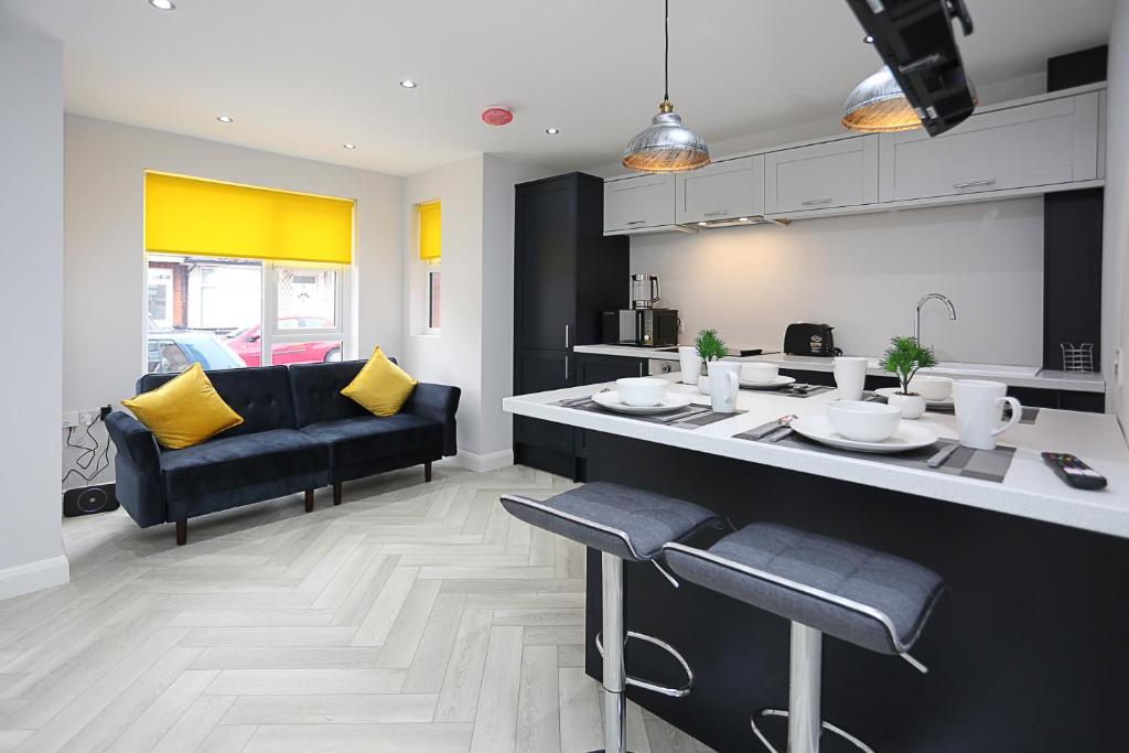 a kitchen and living room with a counter and a couch at No1 Luxury Service Apartments in Belfast