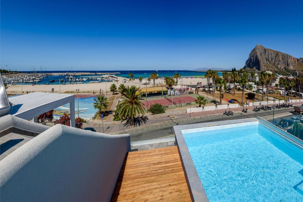 a view of the beach from the balcony of a resort at Residence Luce del Mare in San Vito lo Capo