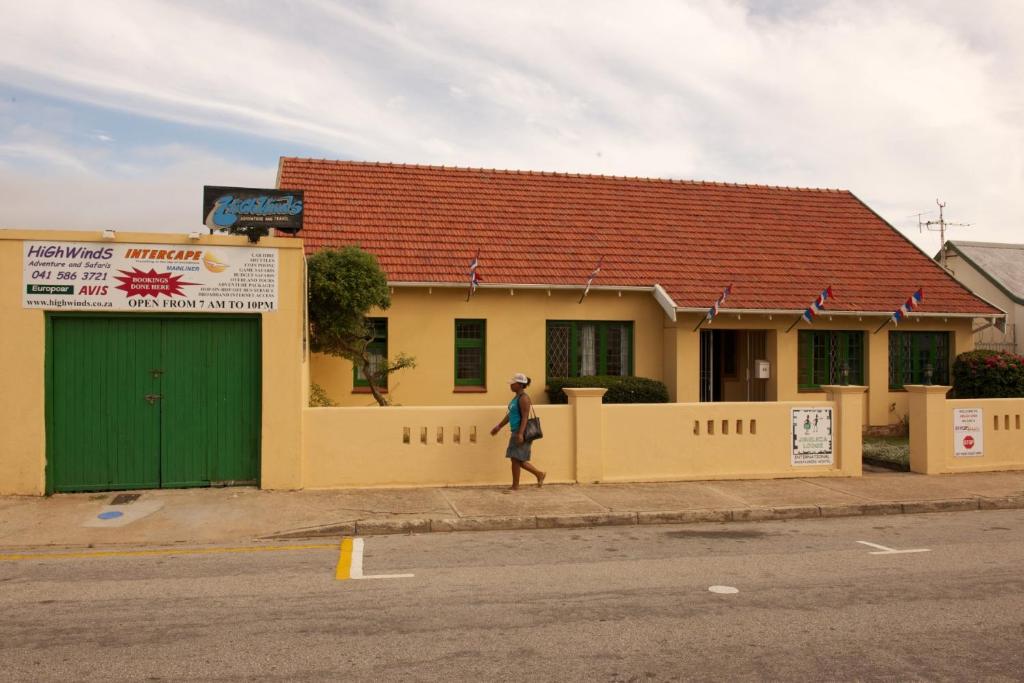 a person walking down a street in front of a building at Jikeleza Lodge in Port Elizabeth