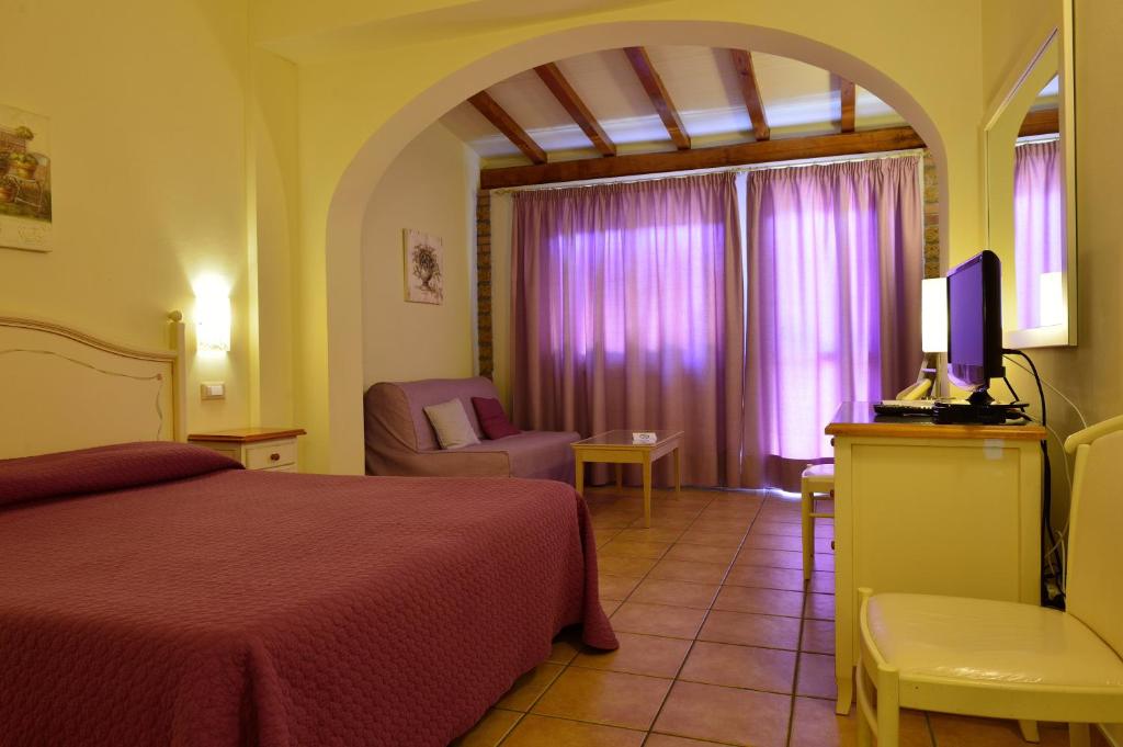 Postel nebo postele na pokoji v ubytování Hotel Acquasanta