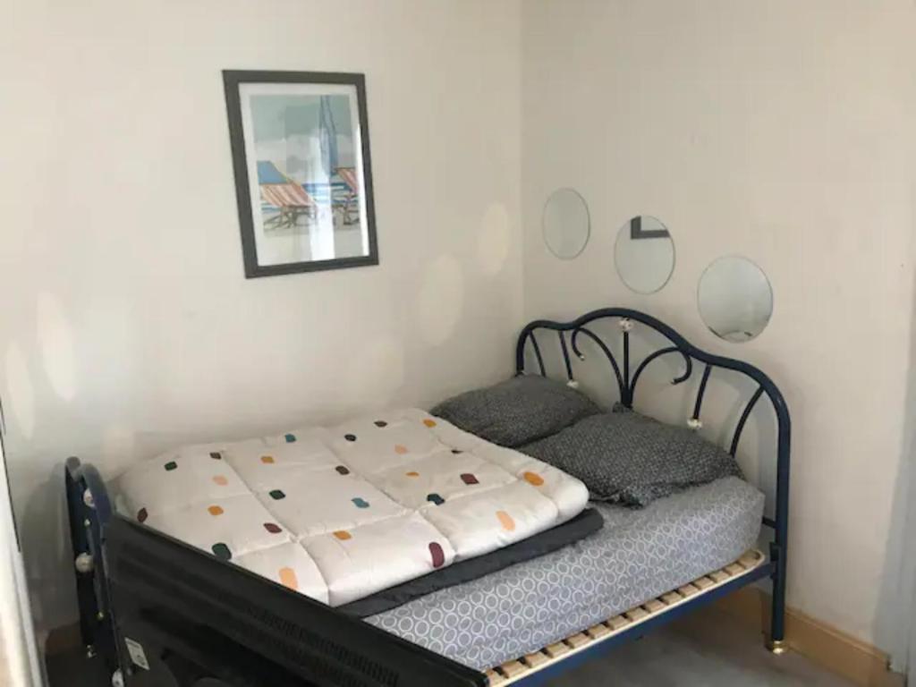 a small bed in a corner of a room at Studio le treport in Le Tréport