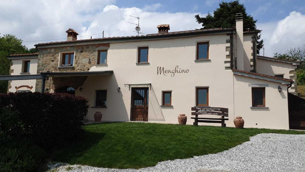 a large white building with a sign on it at Agriturismo Menghino in Nievole