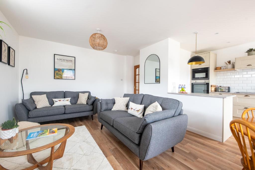 a living room with a couch and a table at End House Inverness in Inverness