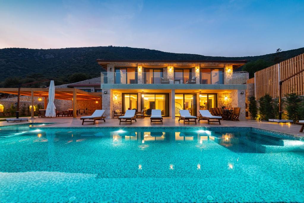 a large swimming pool in front of a house at Water Edge 1 in Kaş