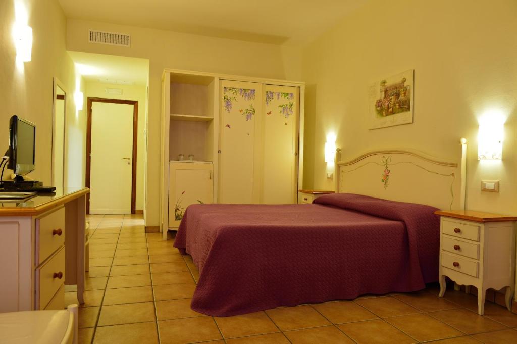 Postel nebo postele na pokoji v ubytování Hotel Acquasanta