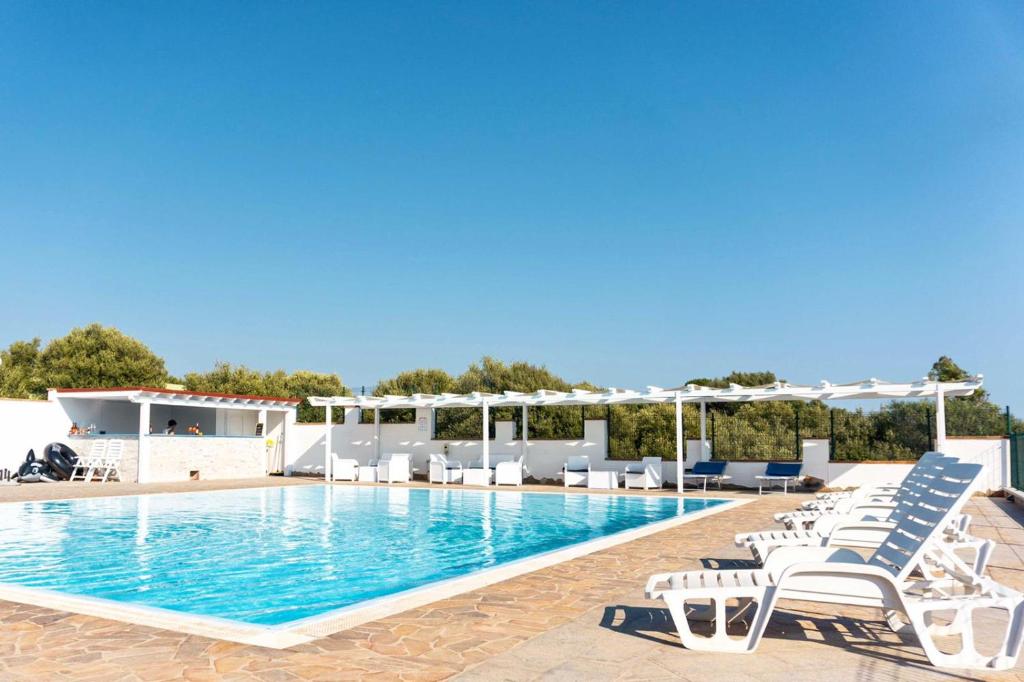 a swimming pool with lounge chairs next to a swimming pool at Villarios Castello in Villarios