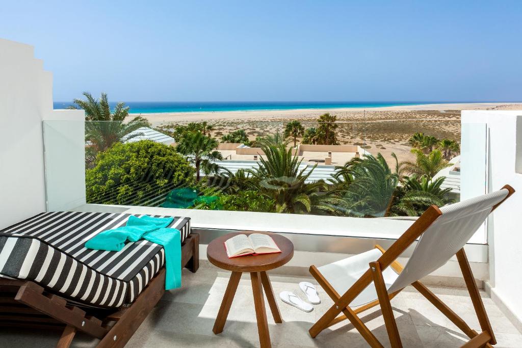 a room with a balcony with a view of the beach at INNSiDE by Meliá Fuerteventura – Adults Only in Costa Calma