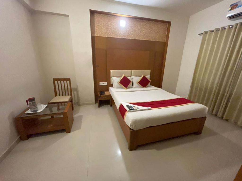 a hotel room with a bed and a table at hotel green city in Chennai