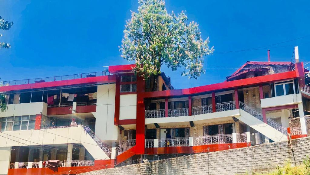 a building with a tree on top of it at Hotel sun paradise in Nainital