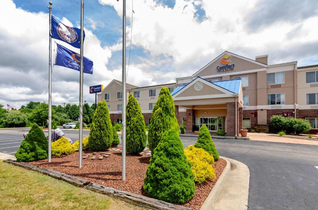 un hotel con dos banderas frente a un edificio en Comfort Inn & Suites Hillsville I-77 en Hillsville