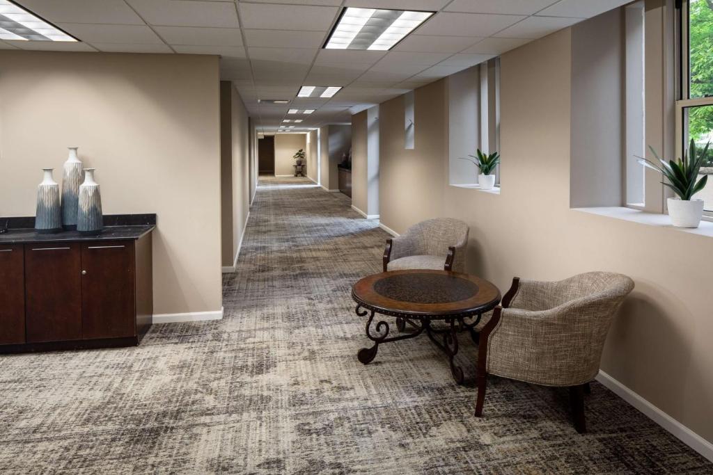 a hallway in a office with a table and chairs at The Elms Hotel & Spa, a Destination by Hyatt Hotel in Excelsior Springs