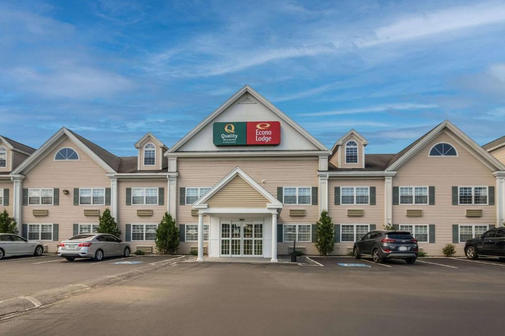 a large building with cars parked in a parking lot at Quality Inn & Suites in Auburn