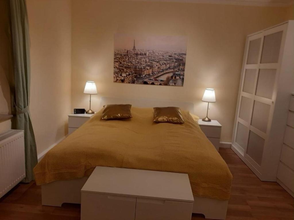 una camera con un grande letto e due lampade di Schöne Ferienwohnung mit Balkon und Garten a Nonnweiler