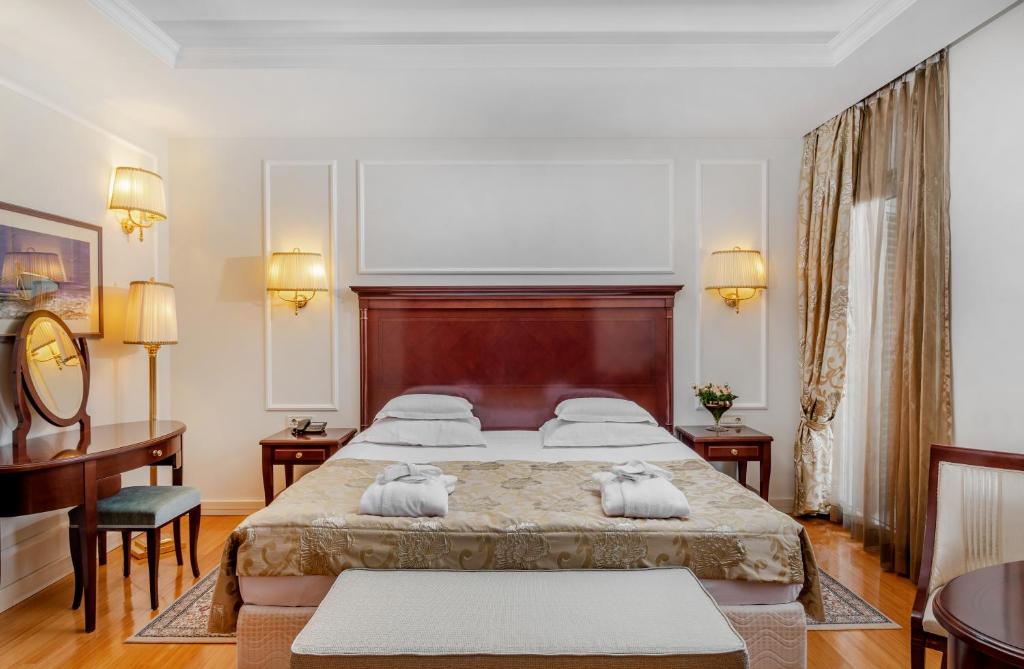 Postel nebo postele na pokoji v ubytování Hotel President Solin