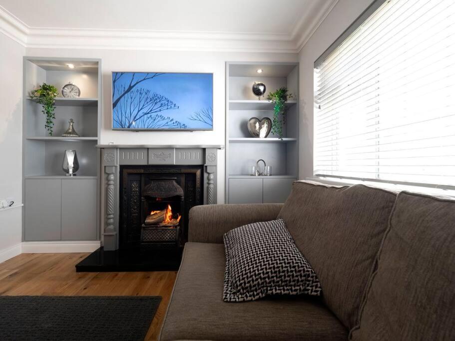 a living room with a couch and a fireplace at Rose Haven private home between Dungannon & Omagh in Dungannon