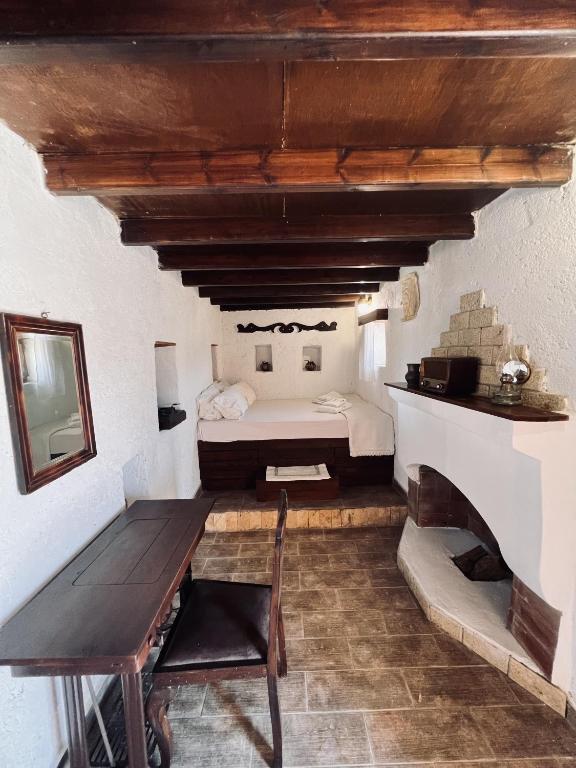 a bedroom with a bed and a table in a room at Lindia Athena Traditional House in Karpathos