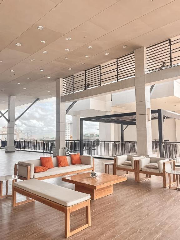 a living room with couches and tables in a building at The Nook at Serin Tagaytay in Tagaytay