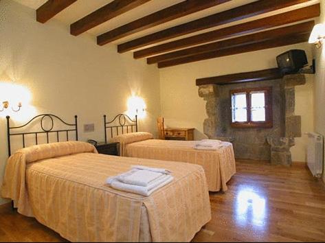 Postel nebo postele na pokoji v ubytování La Casona De Baró