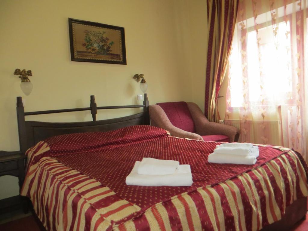 a bedroom with a bed with two towels on it at 100 metriv vid vytyagu in Bukovel