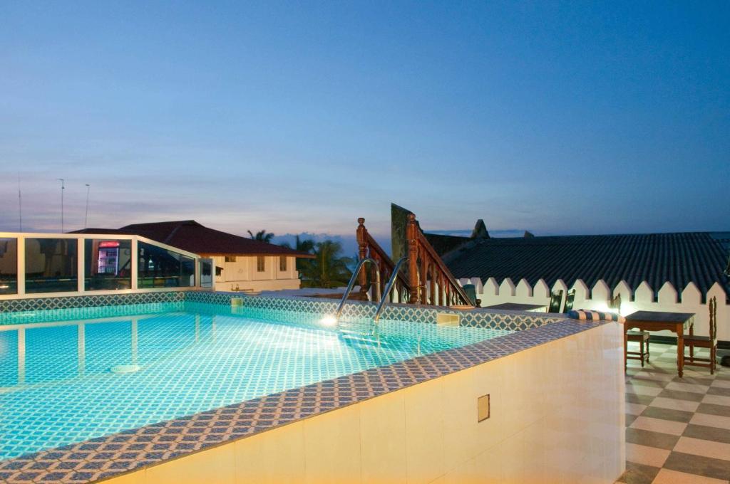 a large swimming pool in a building at Forodhani Park Hotel in Zanzibar City