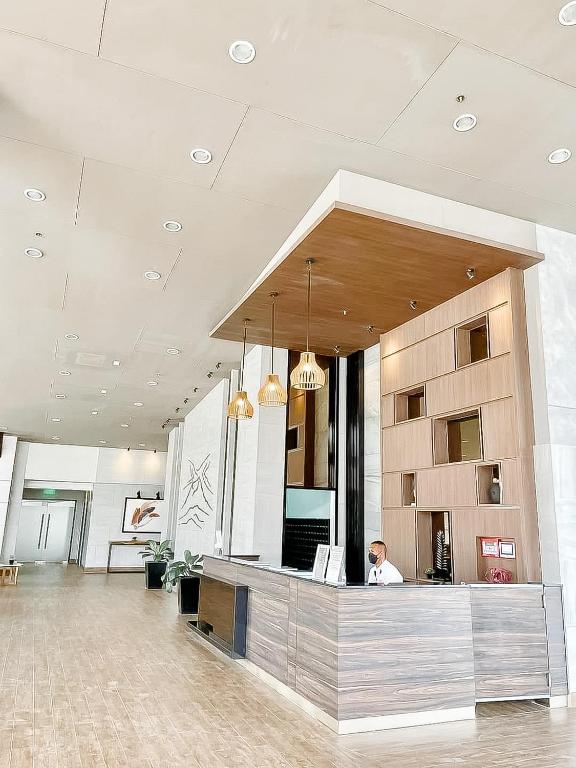 a person sitting at a counter in a lobby at The Nook at Serin Tagaytay in Tagaytay