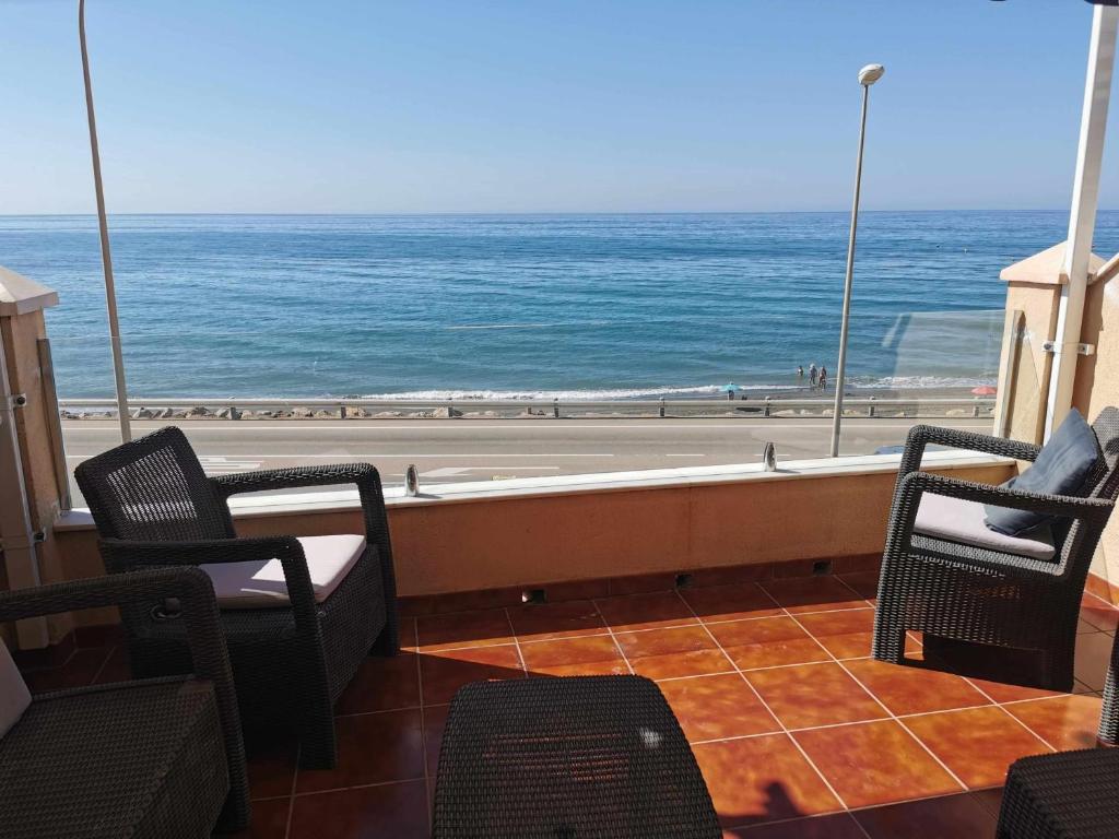 a balcony with chairs and a view of the ocean at Brisa Chilches nº 6 in Vélez-Málaga