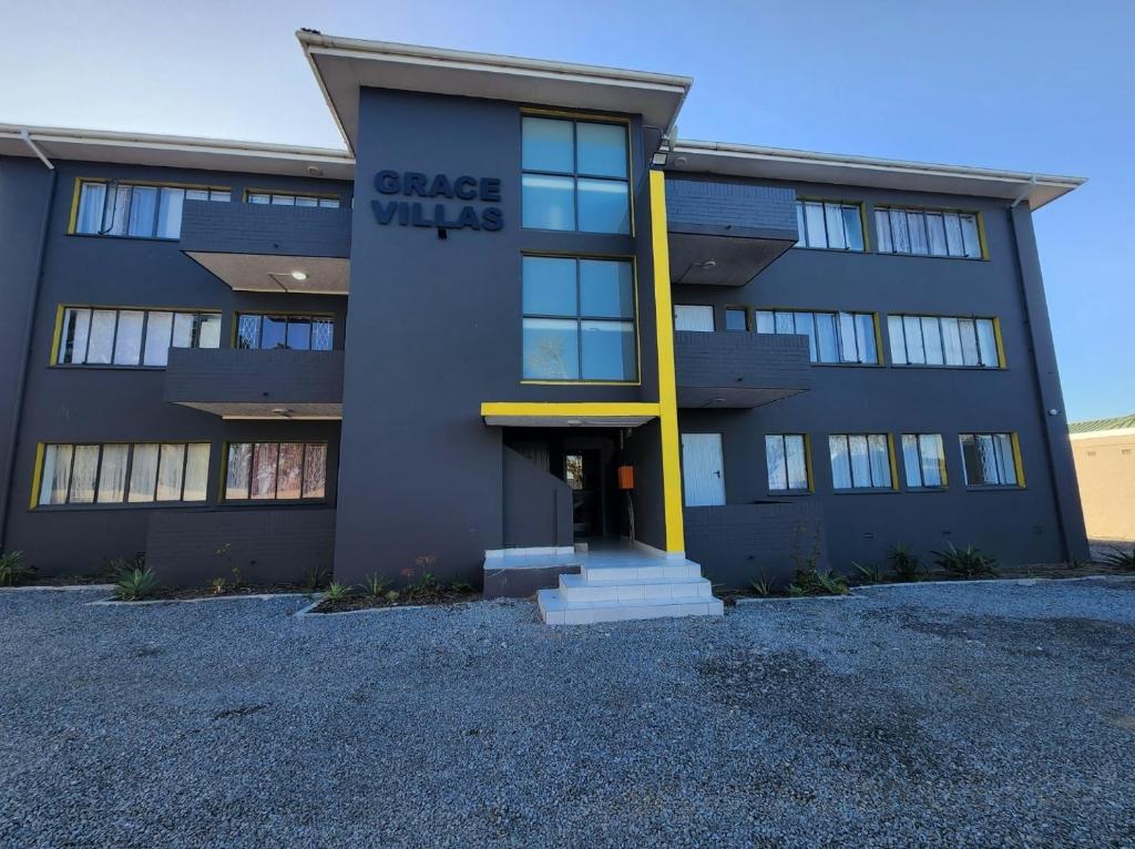 a building with a sign on the front of it at Grace Villas 7 in East London