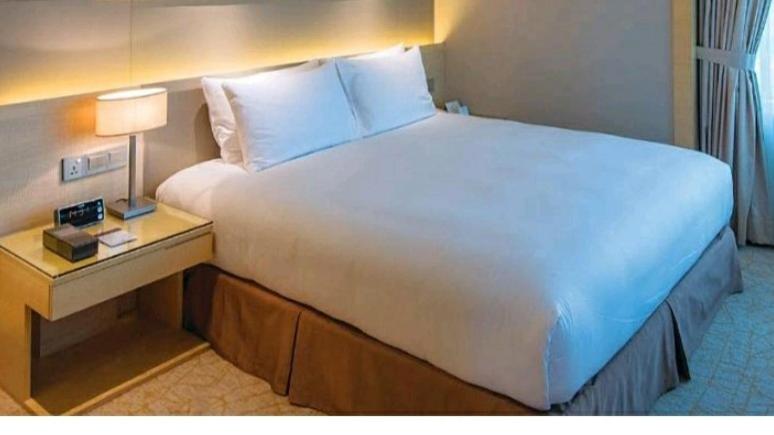 a large white bed in a hotel room at Suasana Suites Homestay10 JB TOWN in Johor Bahru