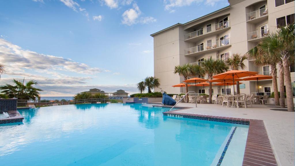 a large swimming pool in front of a hotel at Holiday Inn Club Vacations Galveston Beach Resort, an IHG Hotel in Galveston