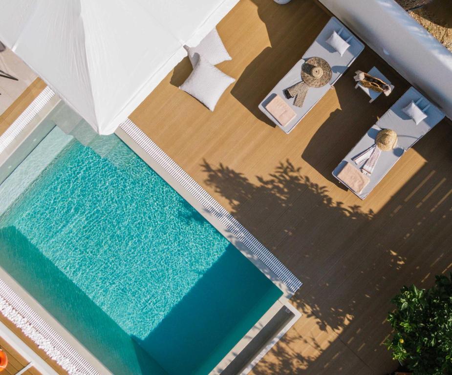 an aerial view of a hotel room with a swimming pool at Sea View Luxury Villa White in Blue in Matala