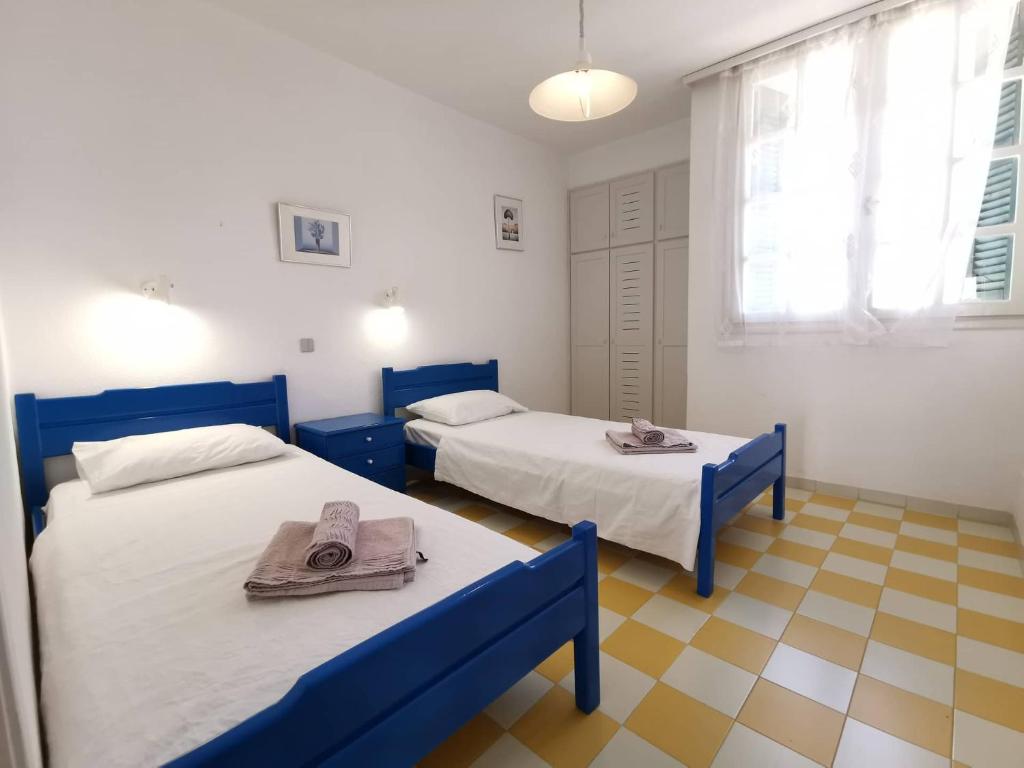 a room with two beds with towels on them at sea house in Koutsounari