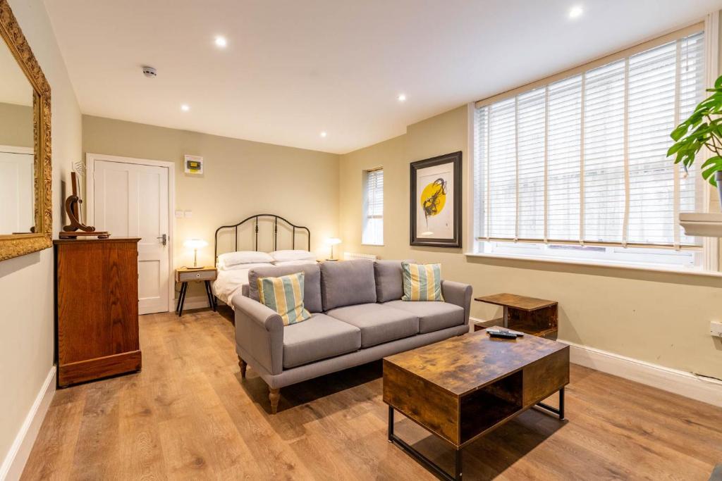 a living room with a couch and a bed at Cromer Town Apartment 1 - Norfolk Holiday Properties in Cromer