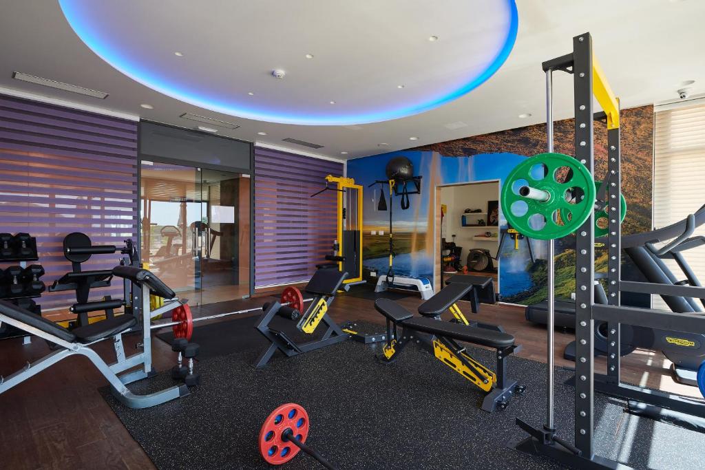 a gym with treadmills and weights in a room at Hotel Adria in Dubrovnik