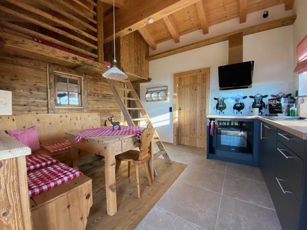 a kitchen and dining room with a table and a stove at Chalet Bergliebe in Brilon